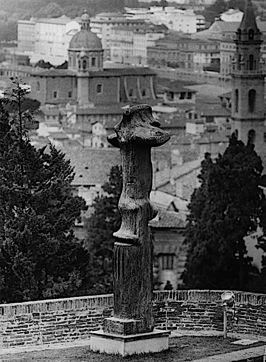 Black-and-white photograph of a Henry Moore sculpture, "Upright Motive No. 1: Glenkiln Cross," in the Forte di Belvedere, Florence