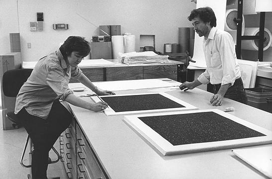 Vija Celmins signing Strata (9.2) with assistance from curator William B. Padien, 1983
