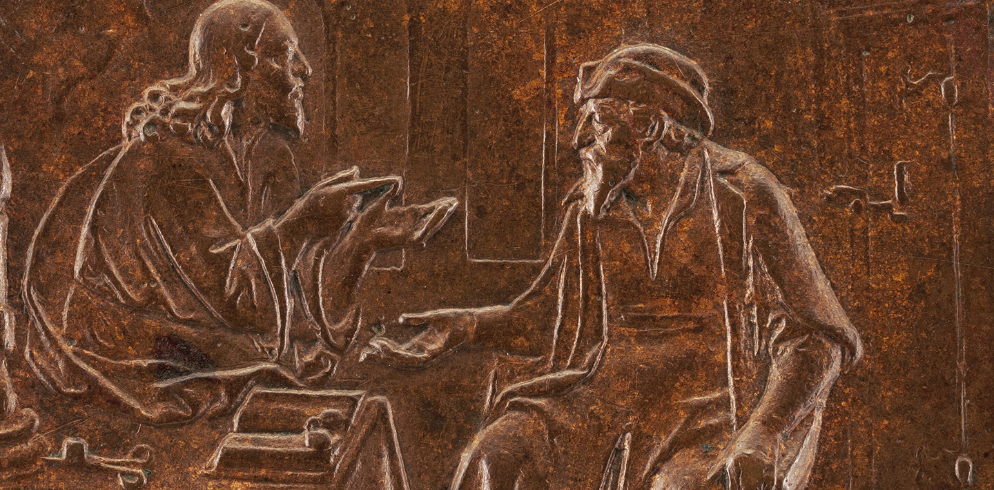 A circular bronze object with an engraving of two men sitting down in the middle of a discussion