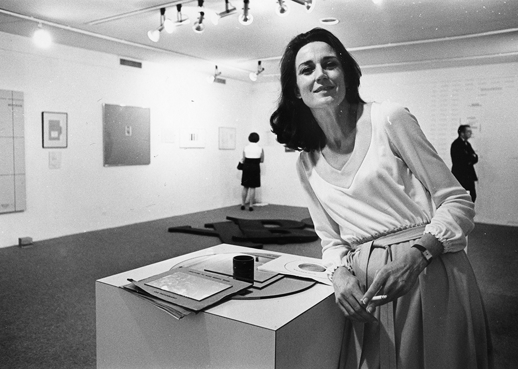 Virginia Dwan standing in the 'Language III' installation (May 24–June 18, 1969). Photo courtesy Dwan Archive