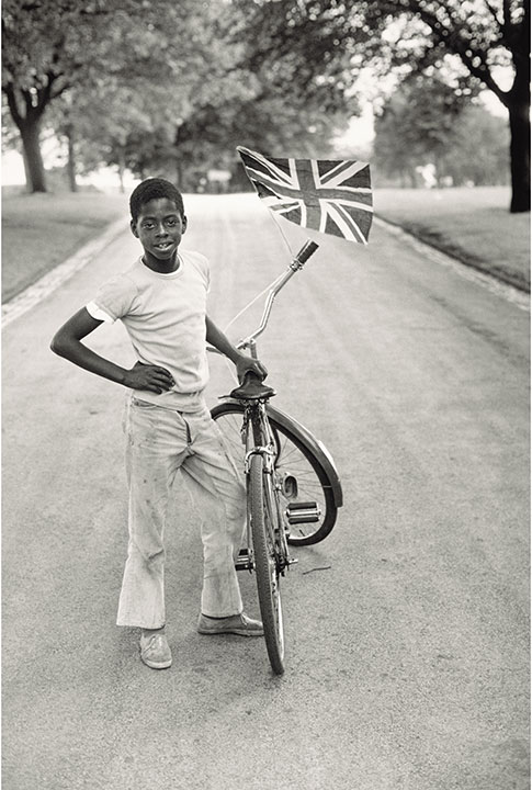 Vanley Burke, "Boy with Flag, Winford in Handsworth Park, 1970"