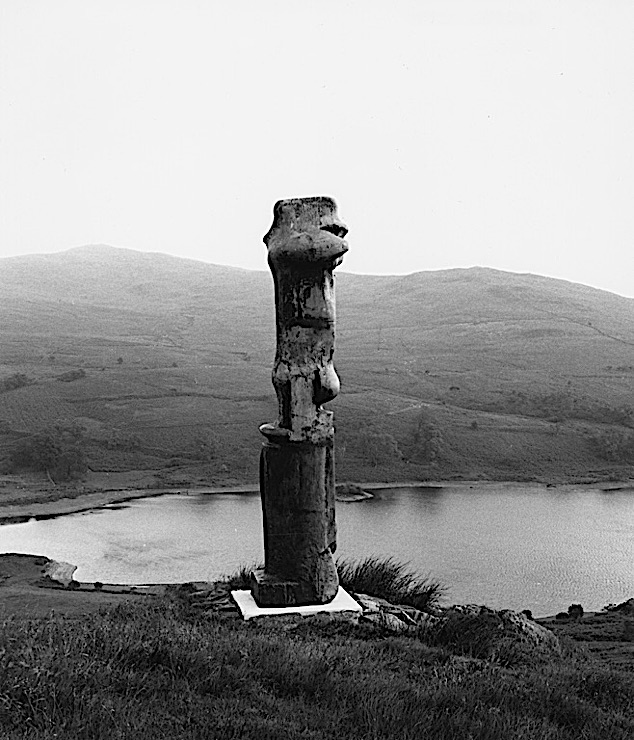 Black-and-white photograph of a Henry Moore sculpture, "Upright Motive No. 1: Glenkiln Cross," in the Glenkiln Sculpture Park, Scotland