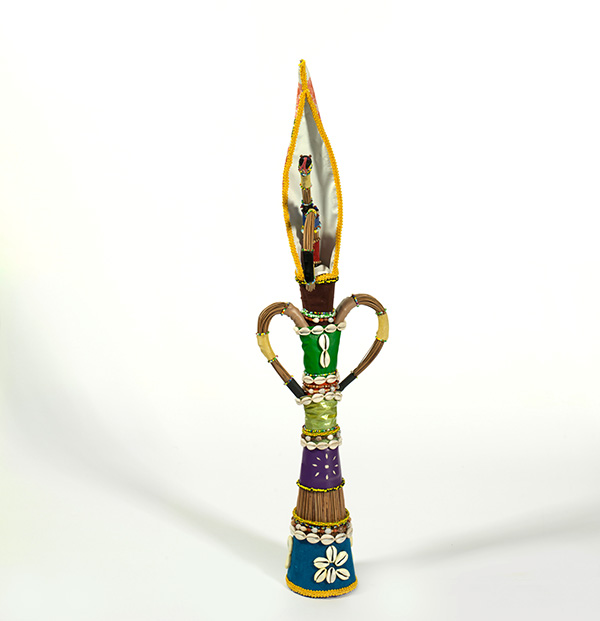 This is a photograph of a brightly beaded object. It stands upright with two handles on either side