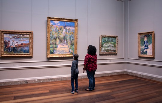 Visitors discuss Claude Monet's The Artist's Garden at Vétheuil (1881, oil on canvas, National Gallery of Art, Washington, Ailsa Mellon Bruce Collection, 1970.17.45).