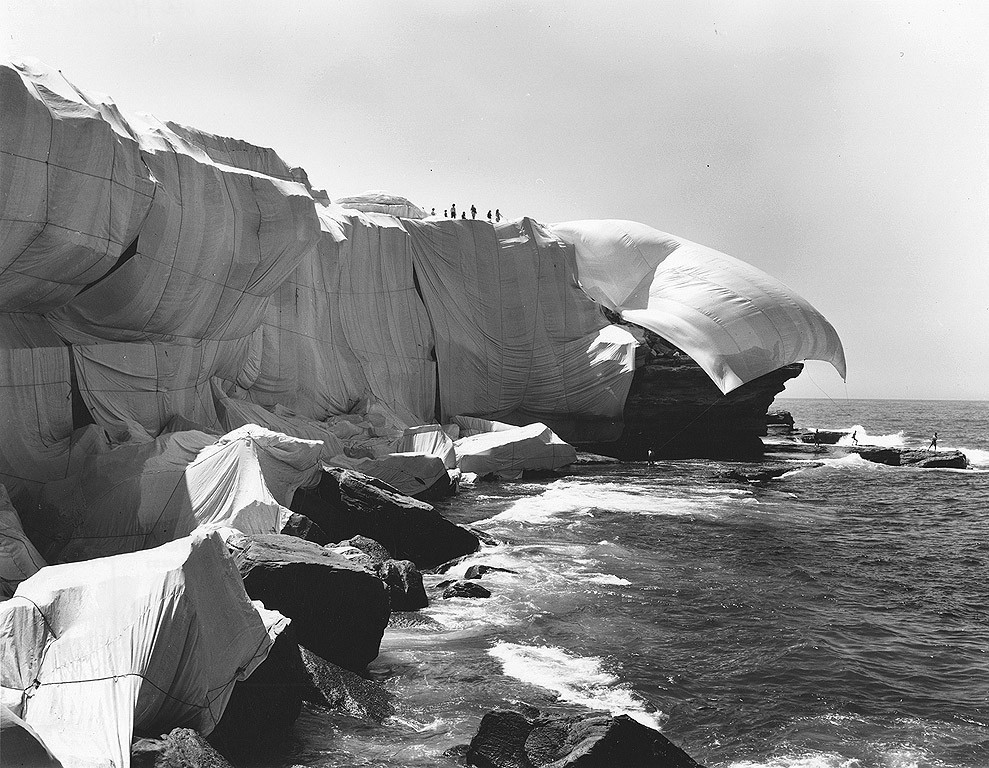 Team on cliffs and shore wrap rock outcrop