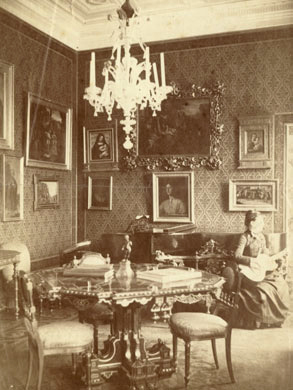 Louise M. Richter playing guitar in the Jean Paul Richter home, 1887