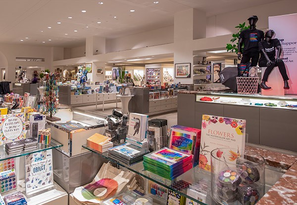 Photograph of the lower level shop in the West Building featuring books, cups, and arts supplies
