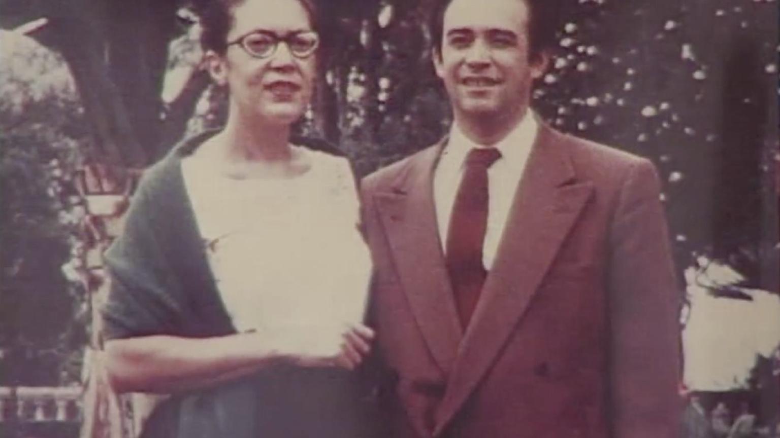 A man and a woman standing side-by-side and smiling.