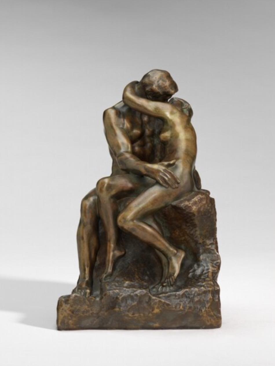A couple embraces in this small bronze statue. We can not see their faces from this angle.