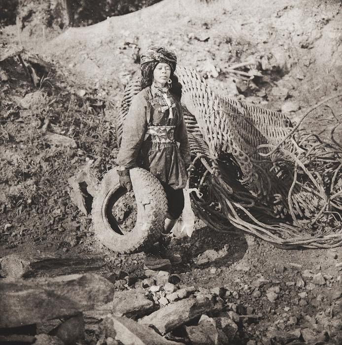 In this photogravure, Chakaia Booker depicts herself as a mythical being foraging in a harsh, industrial landscape.
