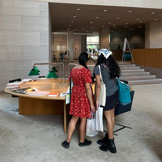 Visitors looking at books on display in the National Gallery of Art Library.