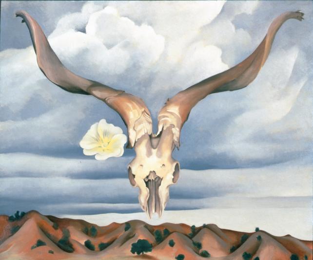 A ram's skull with a flower, a cloudy sky, and mountains in the background.