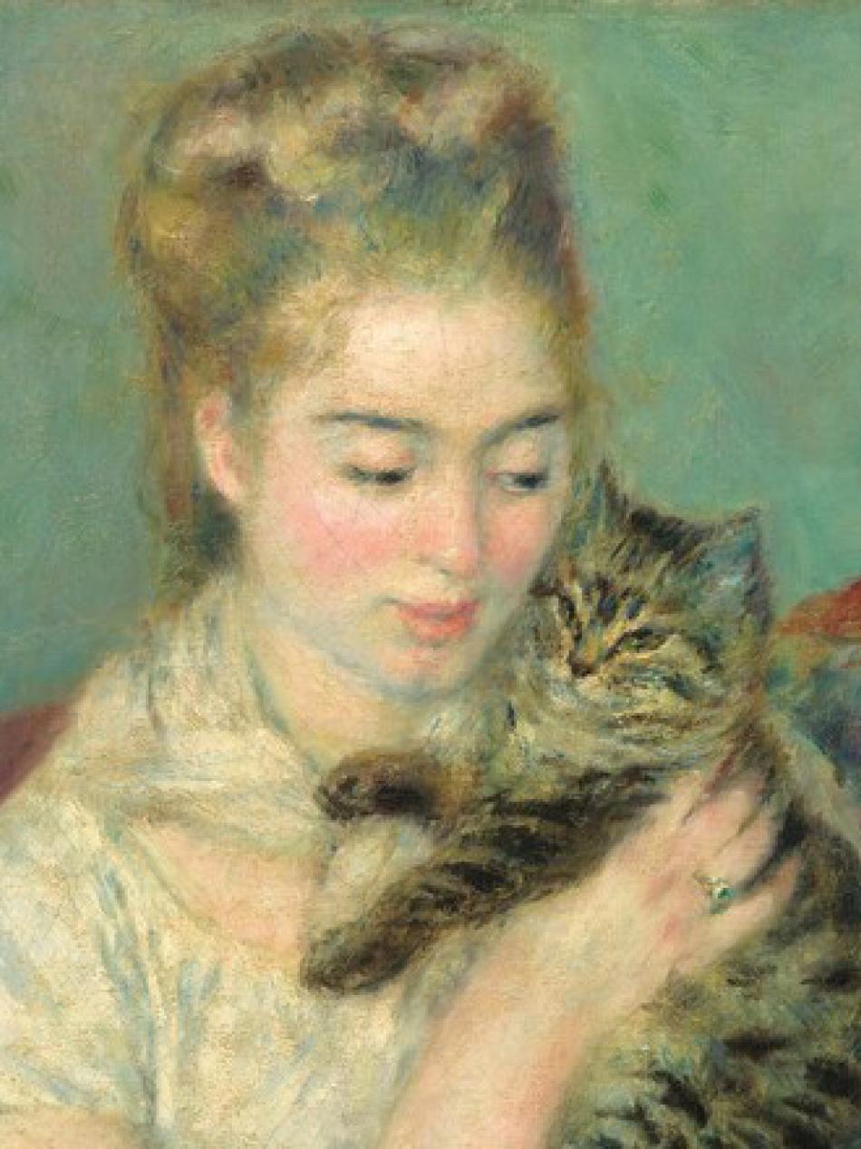 A young woman with pale skin and pink cheeks holds a cat.