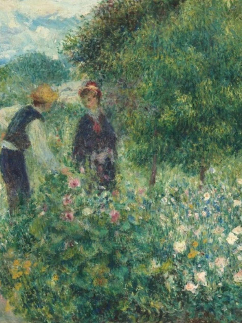 A man and a woman stand in a field of flowers.