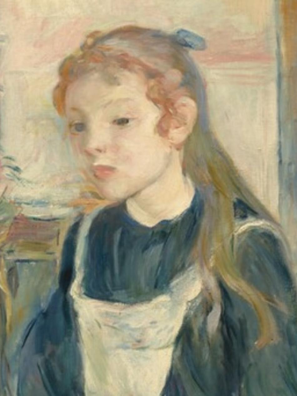 We see a young woman from the shoulders up. She has long hair flowing over her shoulder. She is looking down and to our left.