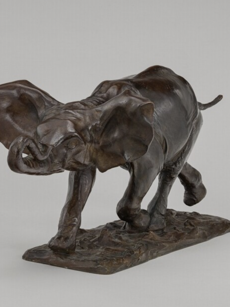 This is a bronze sculpture of an elephant walking.