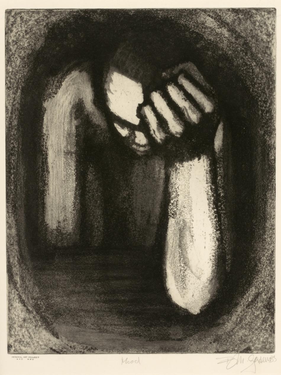 A person slumps over with their head in their hand.