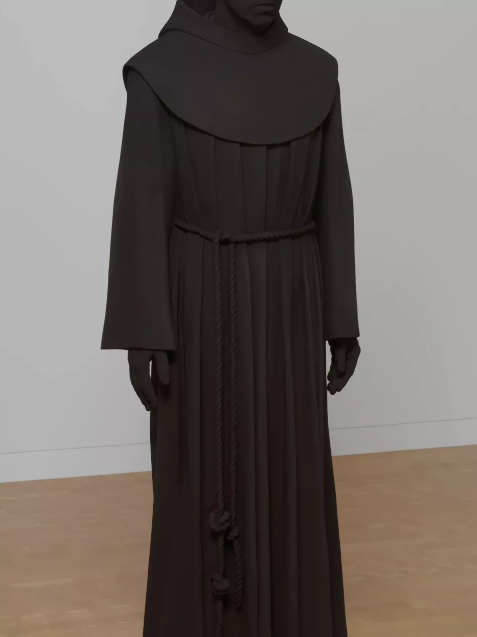 This brown, almost black, sculpture shows a man in robes. He appears to be a monk.